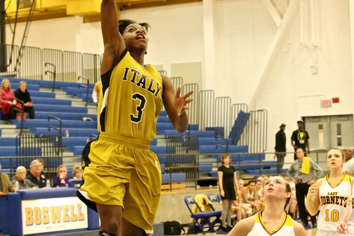 Image: Italy’s Kortnei Johnson(3) soars high for 2-points.