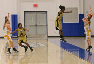 Image: Italy’s Kendra Copeland(10) and Kortnei Johnson(3) defend against the inbound pas.