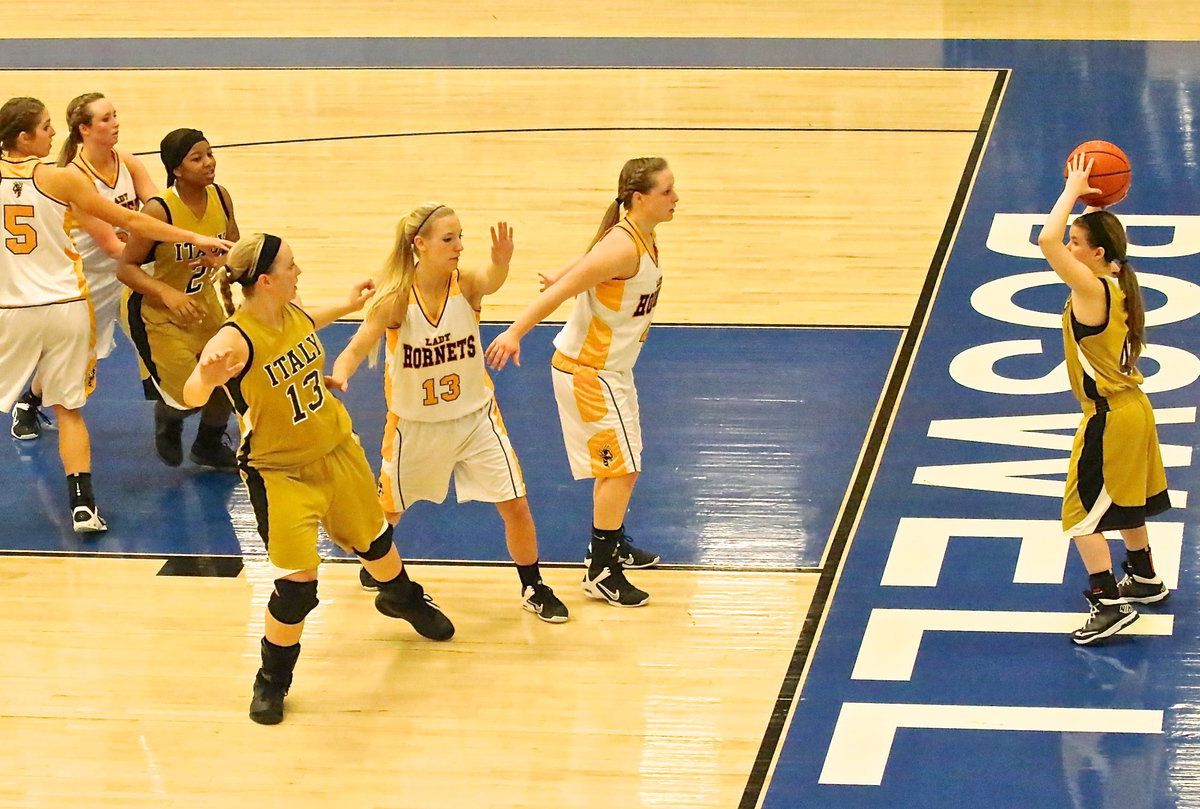 Image: Lady Gladiator Tara Wallis(4) tries to pass the ball into teammates Bernice Hailey(2) or Jaclynn Lewis(13).