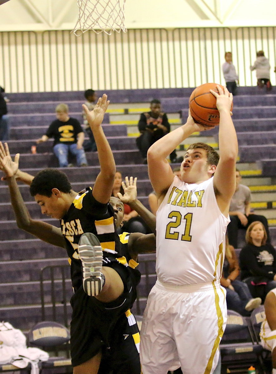 Image: Gladiator Zain Byers(21) avoids shot blockers to get up a shot.