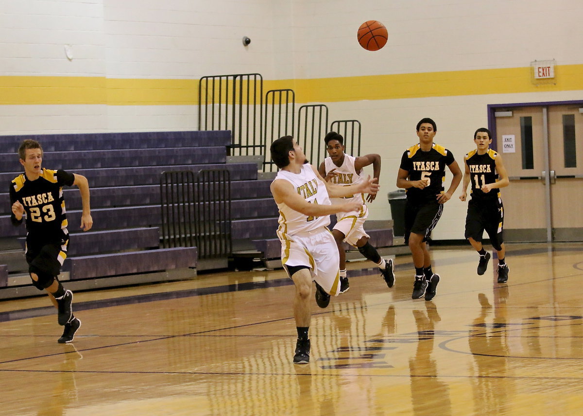 Image: Tre Robertson(22) lobs the ball upcourt to teammate Tyler Anderson(11) who makes the over-the-shoulder catch and then races to the basket.