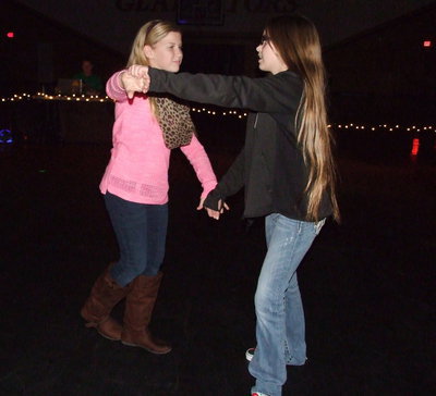 Image: Karson Holley and Karley Nelson practice some dance moves.