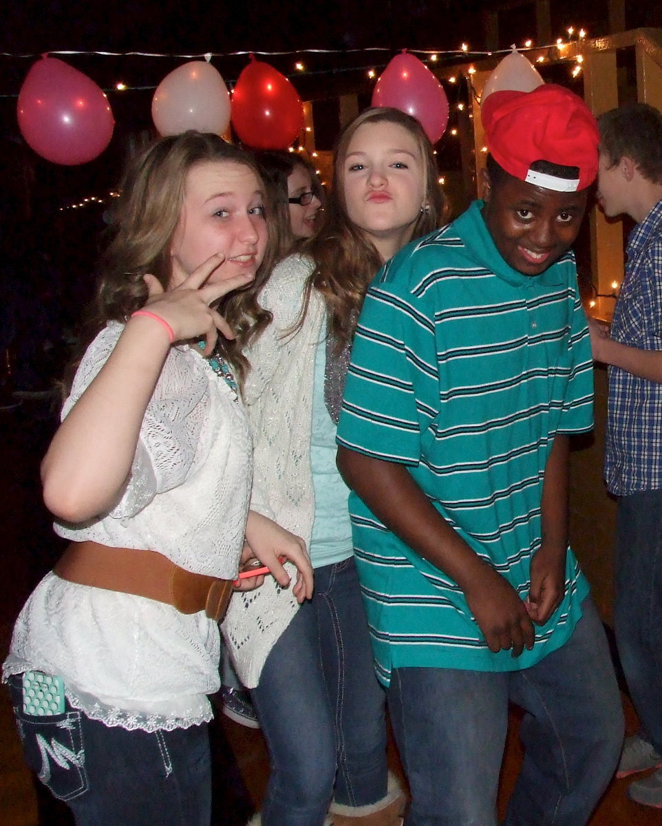 Image: Balloons, lights, action! Rachel Huskins, Kristen Viator and Anthony Powell, Jr. pose for the camera.