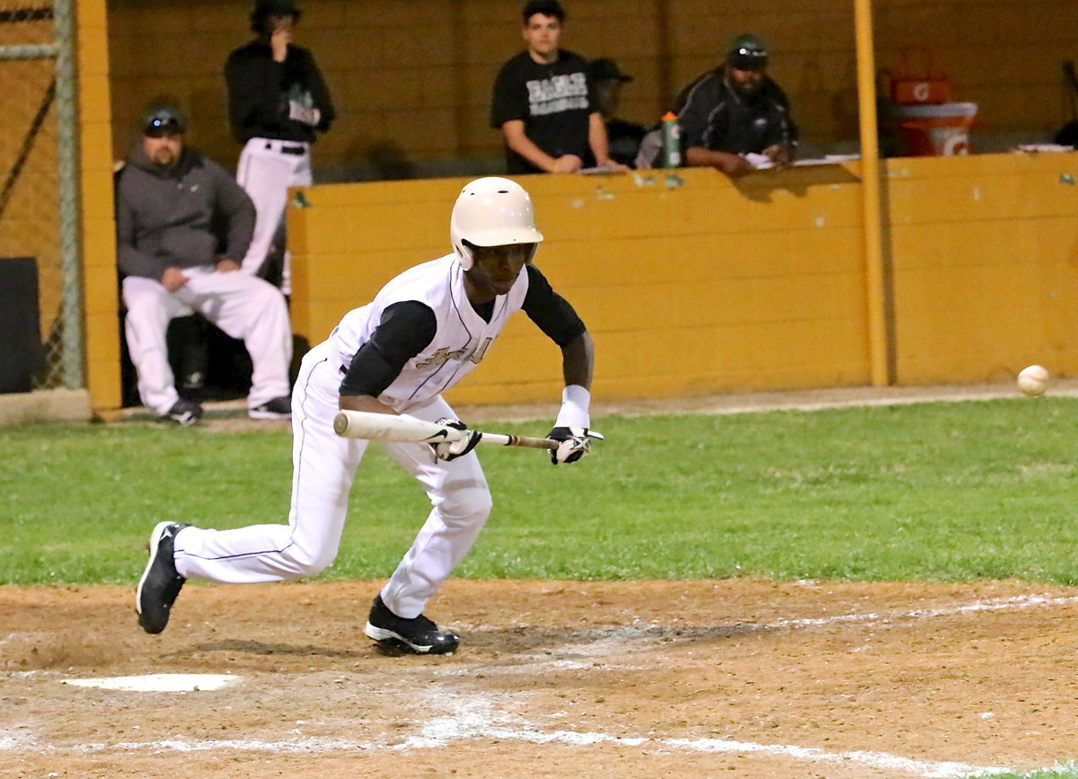 Image: Gladiator senior Eric Carson(2) bunts his way onto base.