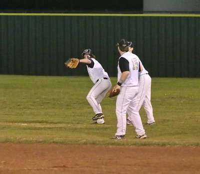 Image: Kyle Fortenberry(14) backs up the play and then throws home to hold an Eagle runner at third base.