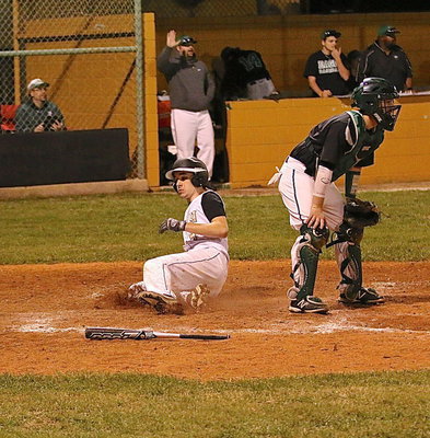 Image: Ryan Connor(4) slides into home to make the score 10-7 with Italy about to load the bases.