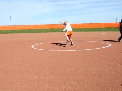 Image: Coach Davis is throwing the softball for his first time on the softball field.