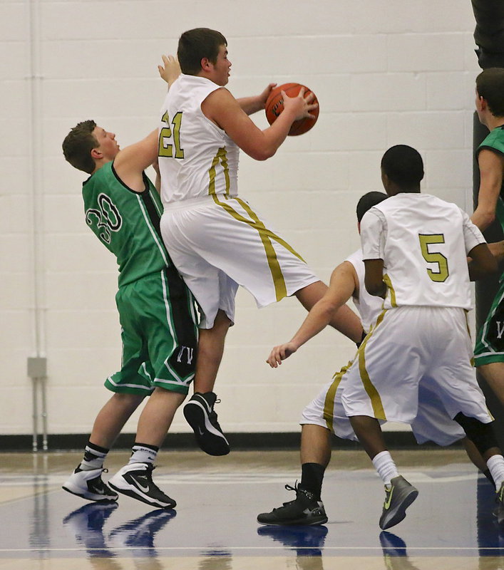 Image: Gladiator Zain Byers(21) secures one of his 10 rebounds against the Eagles.