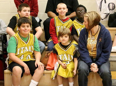 Image: Kerri Rudd waits patiently with Team Italy members before the start of the Special Olympics basketball competition. Back row (L-R): Wyatt Ballard, Charlie Bolin and Damarcus Houston. Front row (L-R): Brothers Mikey South and Frank South.