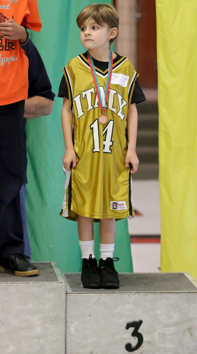 Image: Italy’s Frank South(14) receives his 3rd place medal while standing proudly on the podium of champions.