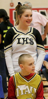 Image: Italy High School Cheerleader Taylor Turner supports special olympian Charlie Bolin(5) as he eagerly awaits to compete.