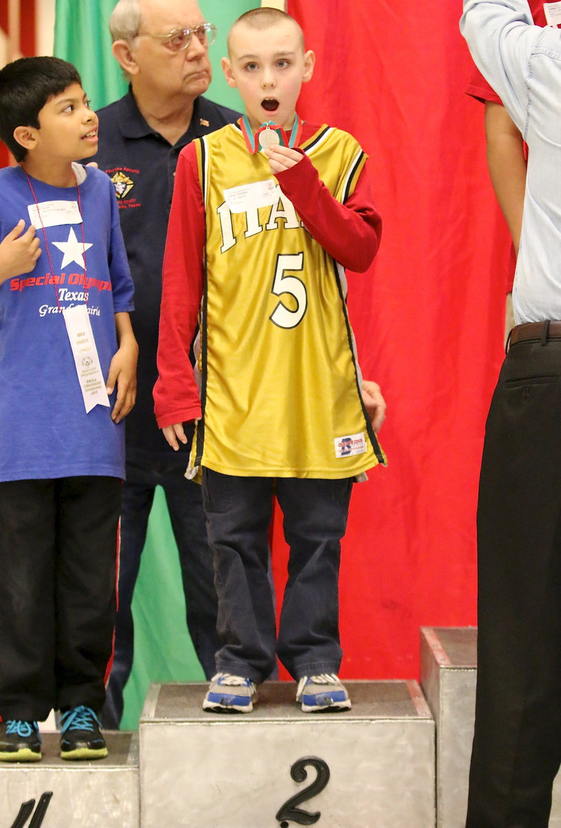 Image: Italy’s Charlie Bolin(5) is extremely proud of his 2nd place medal after it was draped around his neck while standing on the podium of champions.