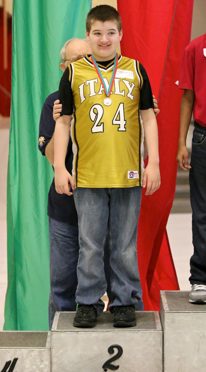 Image: Italy’s Wyatt Ballard(24) is all smiles after receiving his 2nd place medal while standing atop the podium of champions.