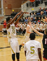 Image: Senior Gladiator Trevon Robertson(22) knocks down one of his five made 3-pointers in the opening period against the Trenton Tigers. Robertson totaled 17-points during the period to give Italy a 23-15 lead going into the second but Trenton survived Italy’s perfect start to win the Area championship, 76-57.