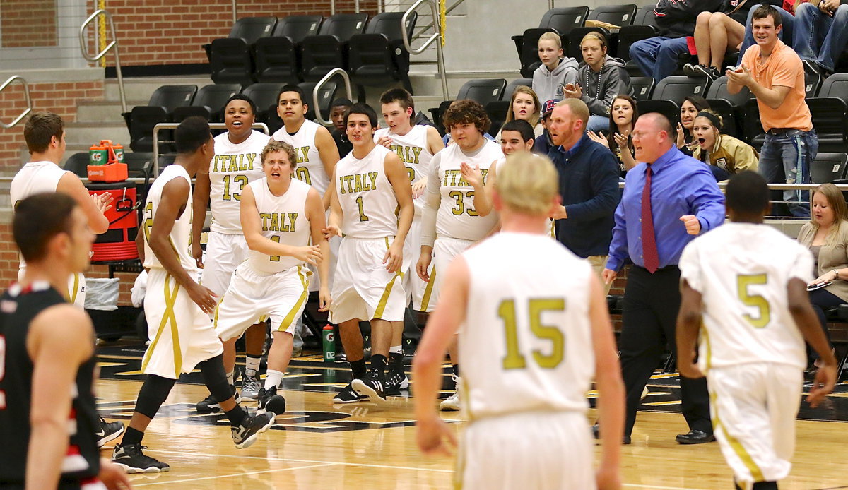 Image: Bailey Walton(4) leads the cheers for Trevon Robertson(22) after Robertson pelted Trenton with a barrage of 3-pointers to set the tone in the opening minutes.