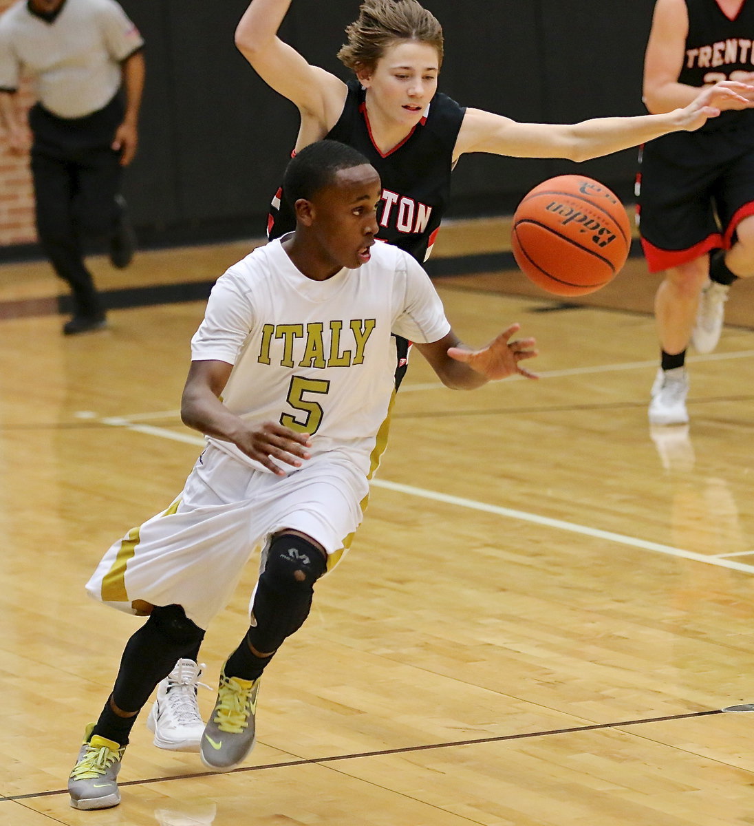 Image: Freshman guard Kevin Johnson(5) tracks down a loose ball and then turn towards the Italy basket.