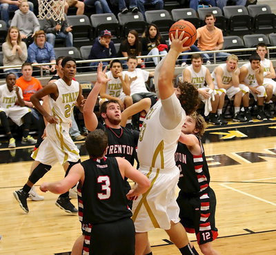 Image: Senior Gladiator Kevin Roldan(33) skies for the rebound and then puts another shot back up, drawing a shooting foul.