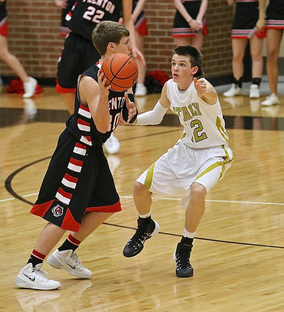 Image: Italy’s Ty Windham(12) mans up against a Trenton ball handler.