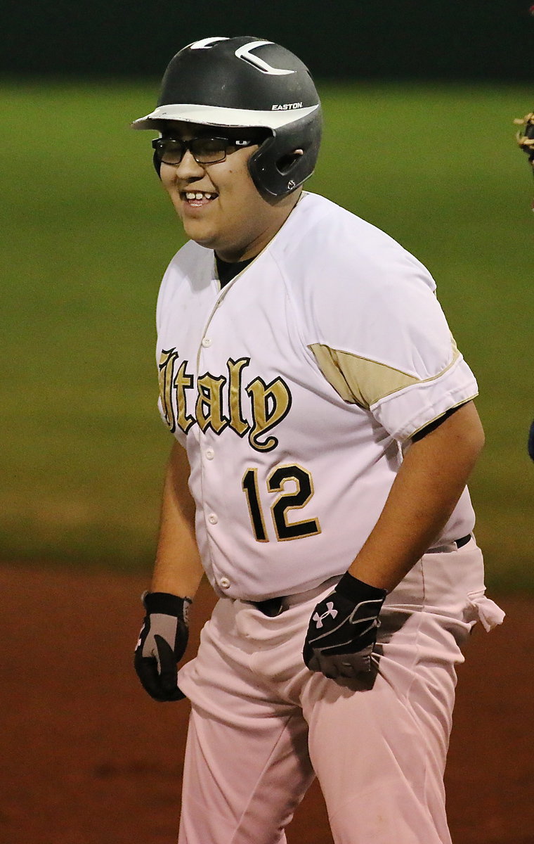 Image: JV Gladiator Pedro Salazar(12) gets on first base after earning a walk against Red Oak Life. The Mustangs eventually won the game but they were unable to keep Salazar from smiling.