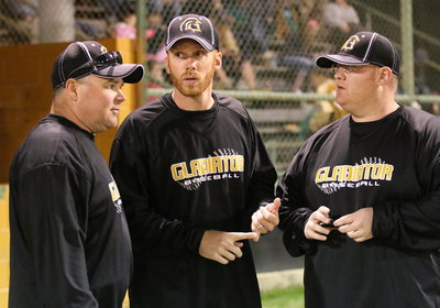 Image: The new baseball regime: Head coach Jon Cady (middle) discusses lineup changes with fellow coaches Jackie Cate (left) and Brandon Ganske.