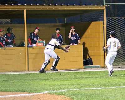 Image: Catcher Kenneth Norwood, Jr.(5) tracks down a foul ball and makes the catch with his bare hand.