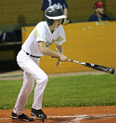 Image: Hunter Ballard(1) hits the ball into play and then races towards first base.