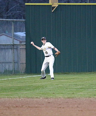 Image: JV Gladiator Michael Hughes(16) makes a play on a ball hit to deep left.