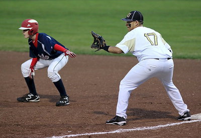 Image: First baseman Tristan Cotten(17) holds a Mustang runner on base.