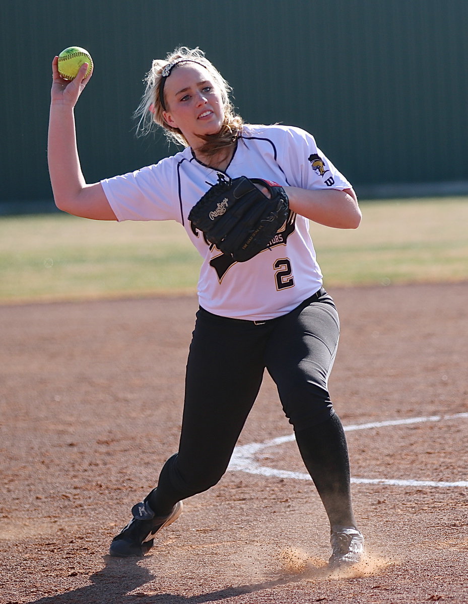 Image: Madison Washington(2) fields a grounder and then throws home for the out.