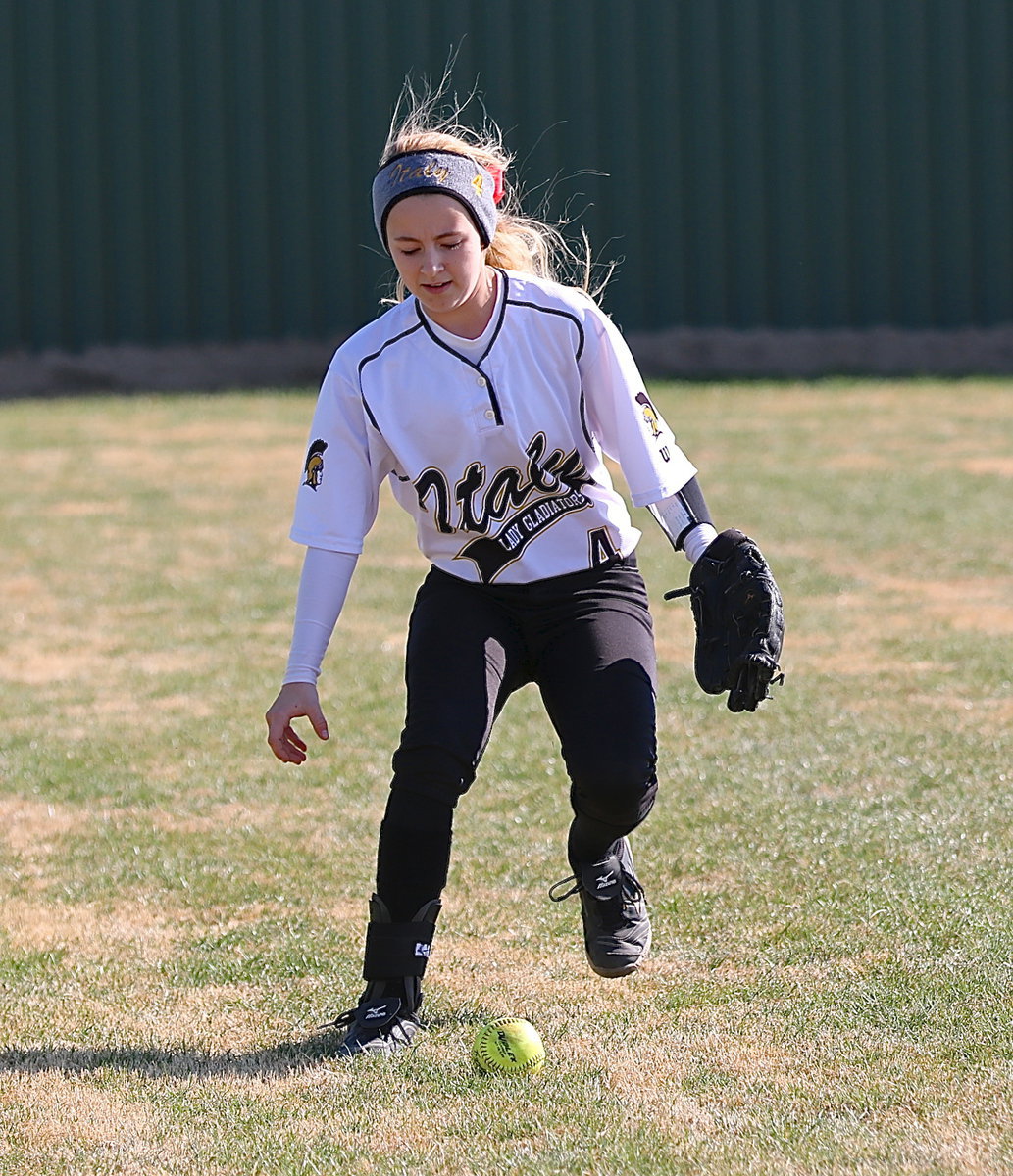 Image: Left fielder Britney Chambers(4) hustles after a foul ball.