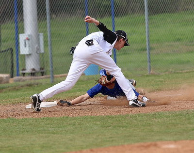 Image: Ty Windham(12) face tags a Rice runner out at third-base.