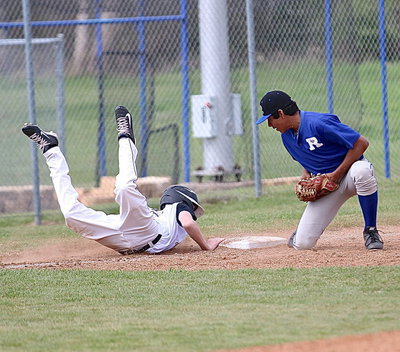 Image: Clayton Miller(6) almost does a full scorpion while diving back to the third-base bag.