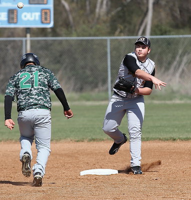Image: Zain Byers(5) executes a double-play with Kerens charged with obstruction.