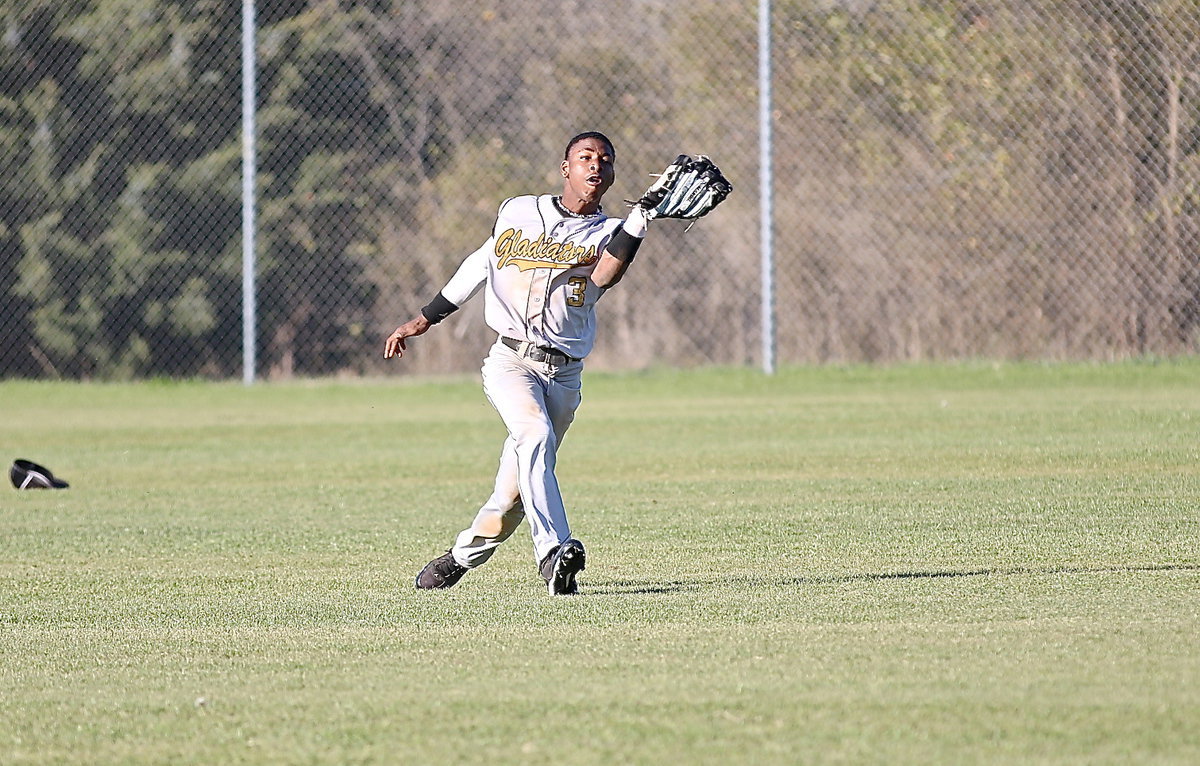 Image: Eric Carson(3) tracks down a fly ball in center field and then…