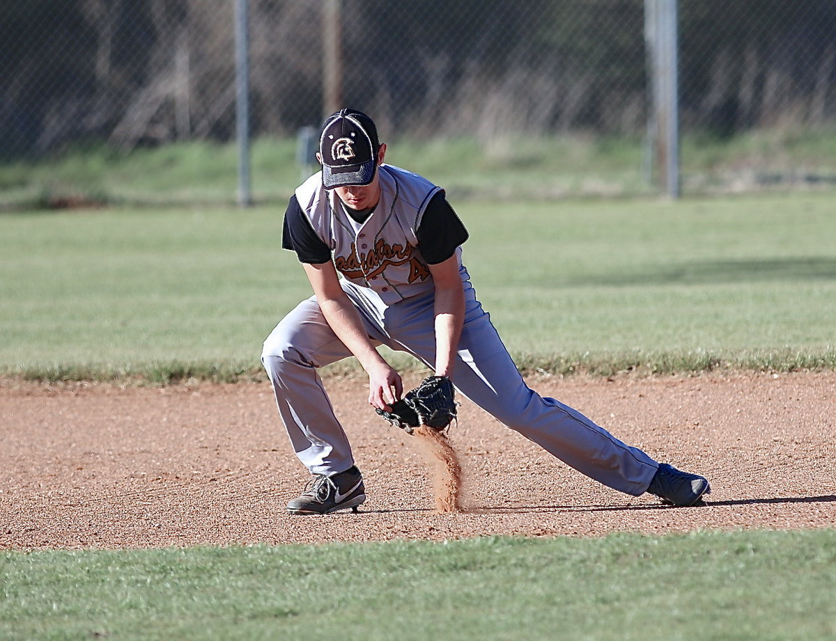 Image: Ryan Connor(4) scoops up a ground ball while playing shortstop.