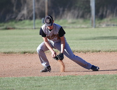 Image: Ryan Connor(4) scoops up a ground ball while playing shortstop.