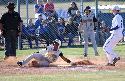 Image: Eric Carson(3) slides across home plate to score an Italy run.