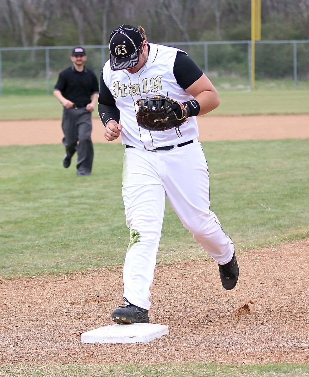 Image: Kevin Roldan(16) secures a ground ball and then steps on the first-base bag for the out.