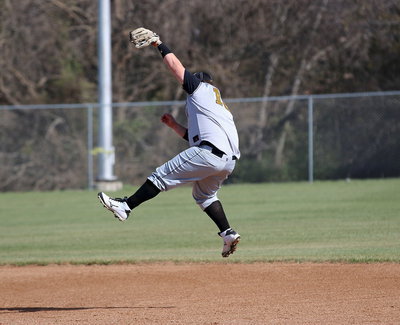 Image: John Byers(18) leaps high to keep a ball from getting out of the infield.