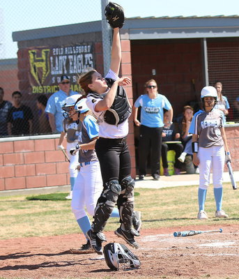 Image: Reicher scores a run but the athleticism of catcher Lillie Perry(9) keeps the situation from escalating.