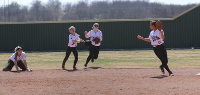 Image: Teamwork and hustle! Left fielder Britney Chambers(4) and center fielder Kelsey Nelson(14) backup the infield with Chambers passing to April Lusk(16) to get a force out at second-base.