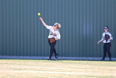 Image: Center fielder Kelsey Nelson(14) gets the ball in with Tara Wallis(5) backing her up from right field.