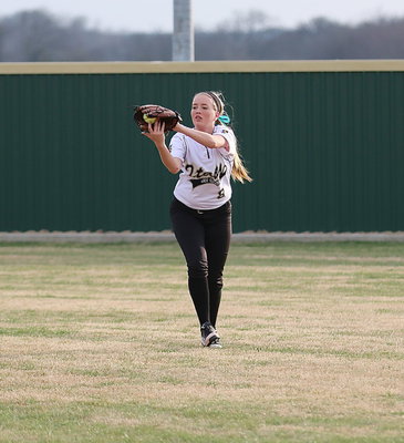 Image: Lady Gladiator Hannah Washington(8) pulls in a fly ball hit to right field for an out.