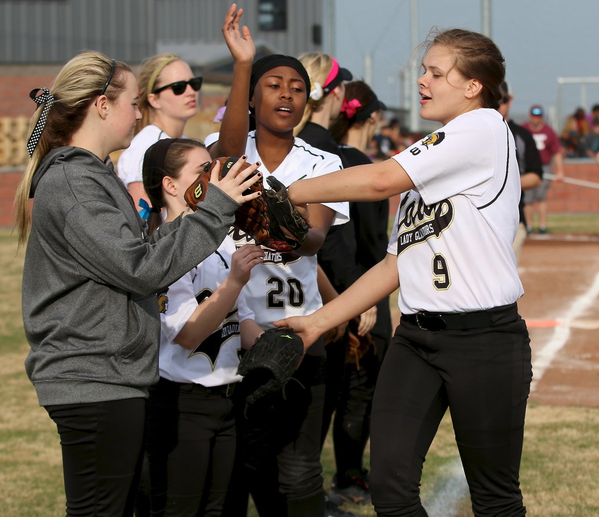 Image: Lillie Perry(9) is wished good luck by her teammates before the Lady Gladiators take on Lake Worth during their final game of the Hillsboro Invitational.