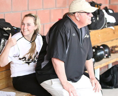 Image: Coach Johnny Jones has the best seat in the dugout thanks to Kelsey Nelson(14).