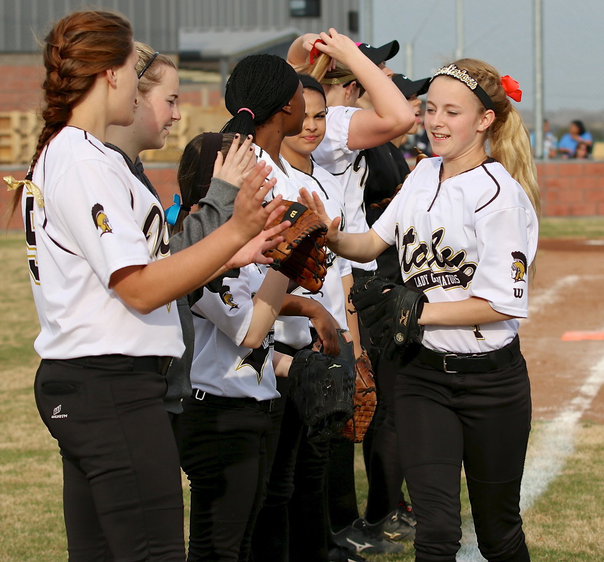 Image: Britney Chambers(4) is wished good luck by her teammates before the Lady Gladiators take on Lake Worth during their final game of the Hillsboro Invitational.