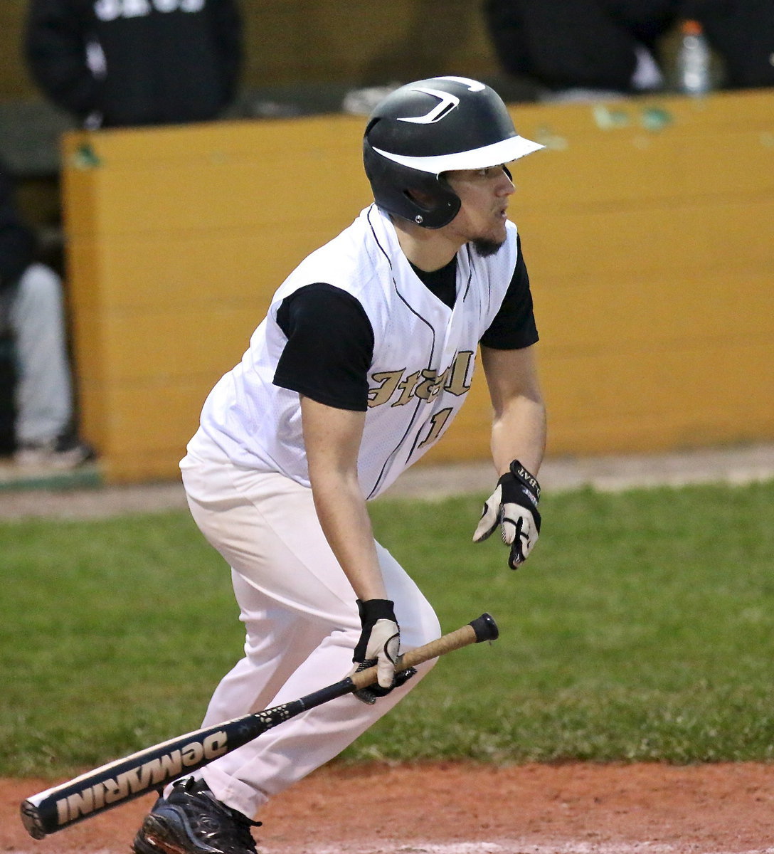 Image: Senior Tyler Anderson puts the ball into play against Hubbard.