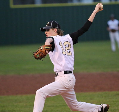 Image: Ty Windham(12) pitches with a wicked wing during the Hubbard game.