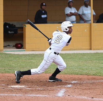 Image: Eric Carson(2) swings away against Roosevelt in round-one.