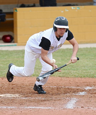 Image: Tyler Anderson(11) tries to bunt his buds around the bases.